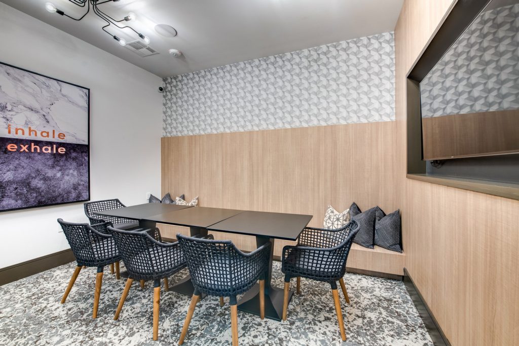 Conference meeting room with lounge and table seating, and television for presentations