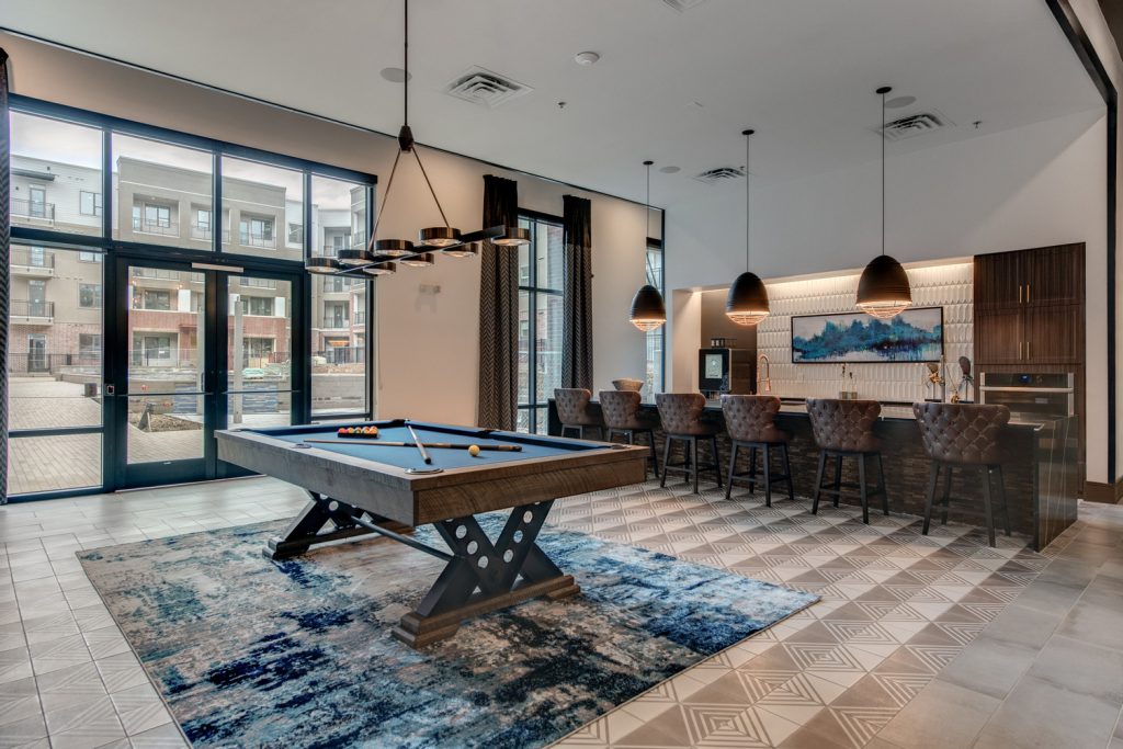 Clubhouse game room area with pool table with outdoor access and clubhouse kitchen access