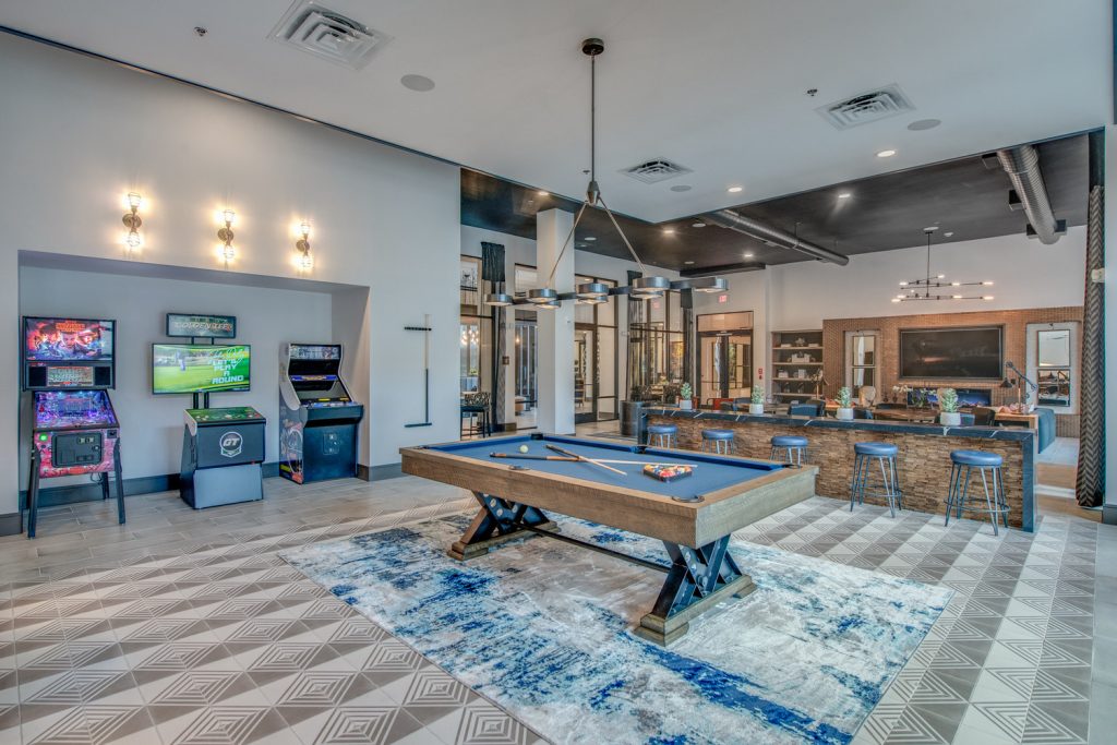 Clubhouse game room area with pool table with outdoor access and clubhouse kitchen access