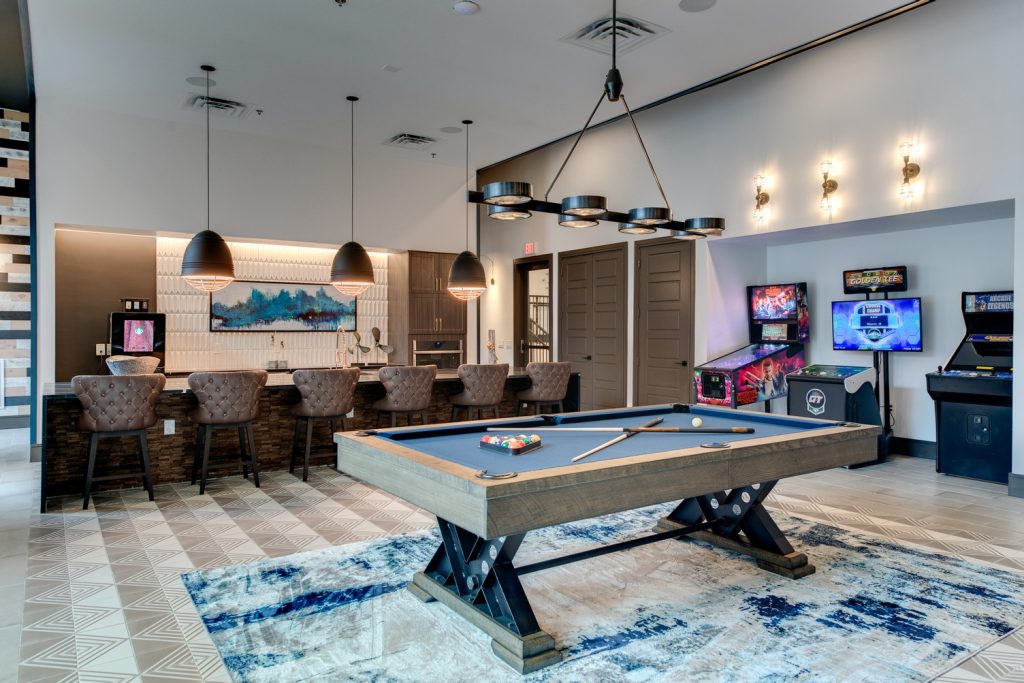 Clubhouse game room area with pool table with outdoor access and clubhouse kitchen access