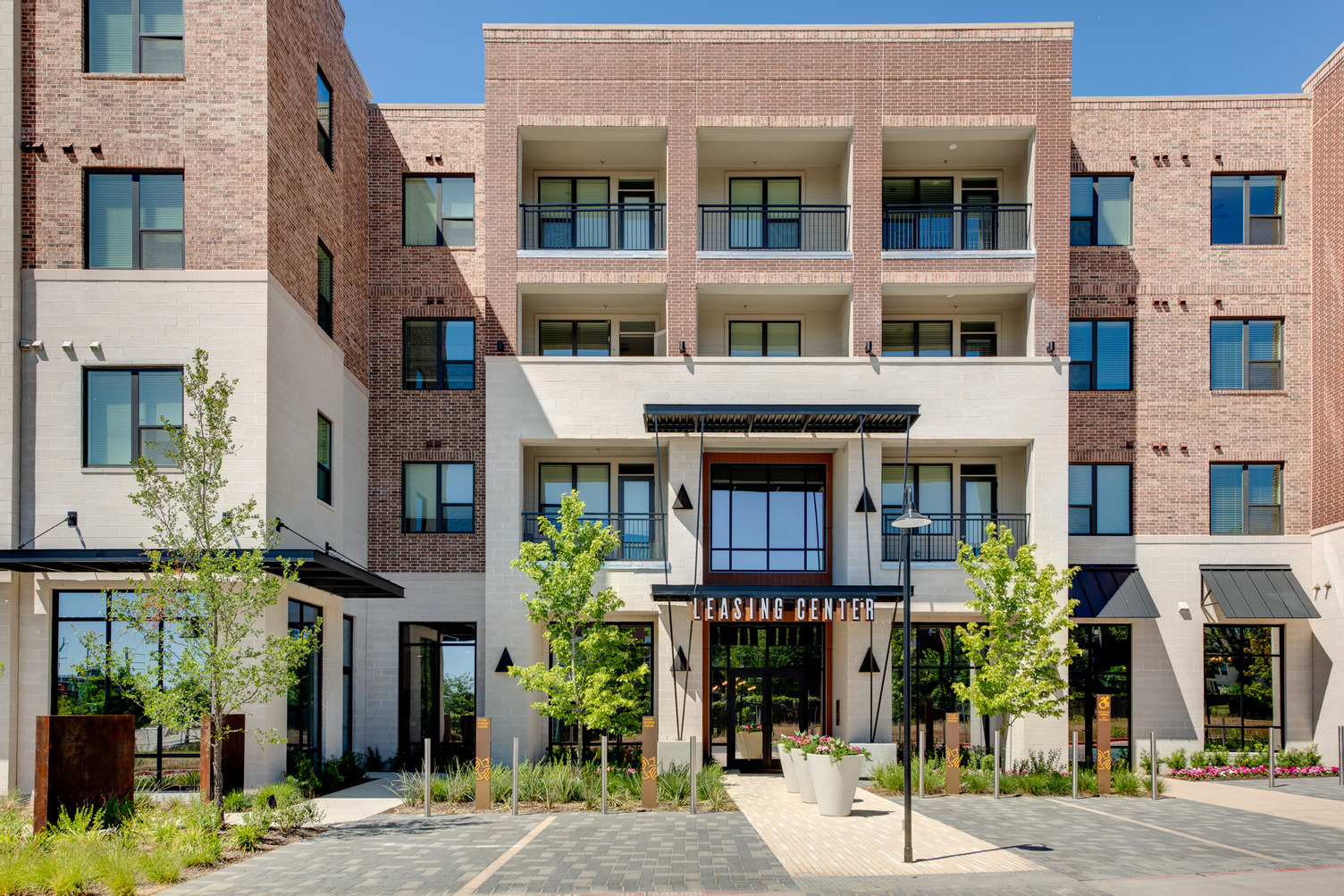 Exterior outside view of entry to leasing office with gardening areas