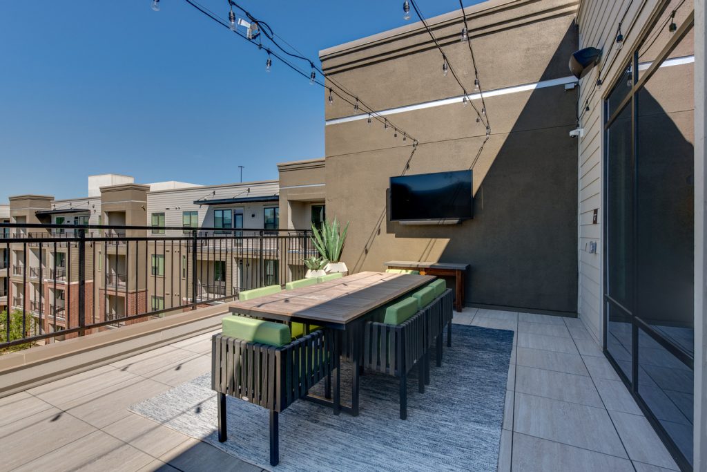 Alt view of Rooftop patio with stringlights, seating, planters, and various other things